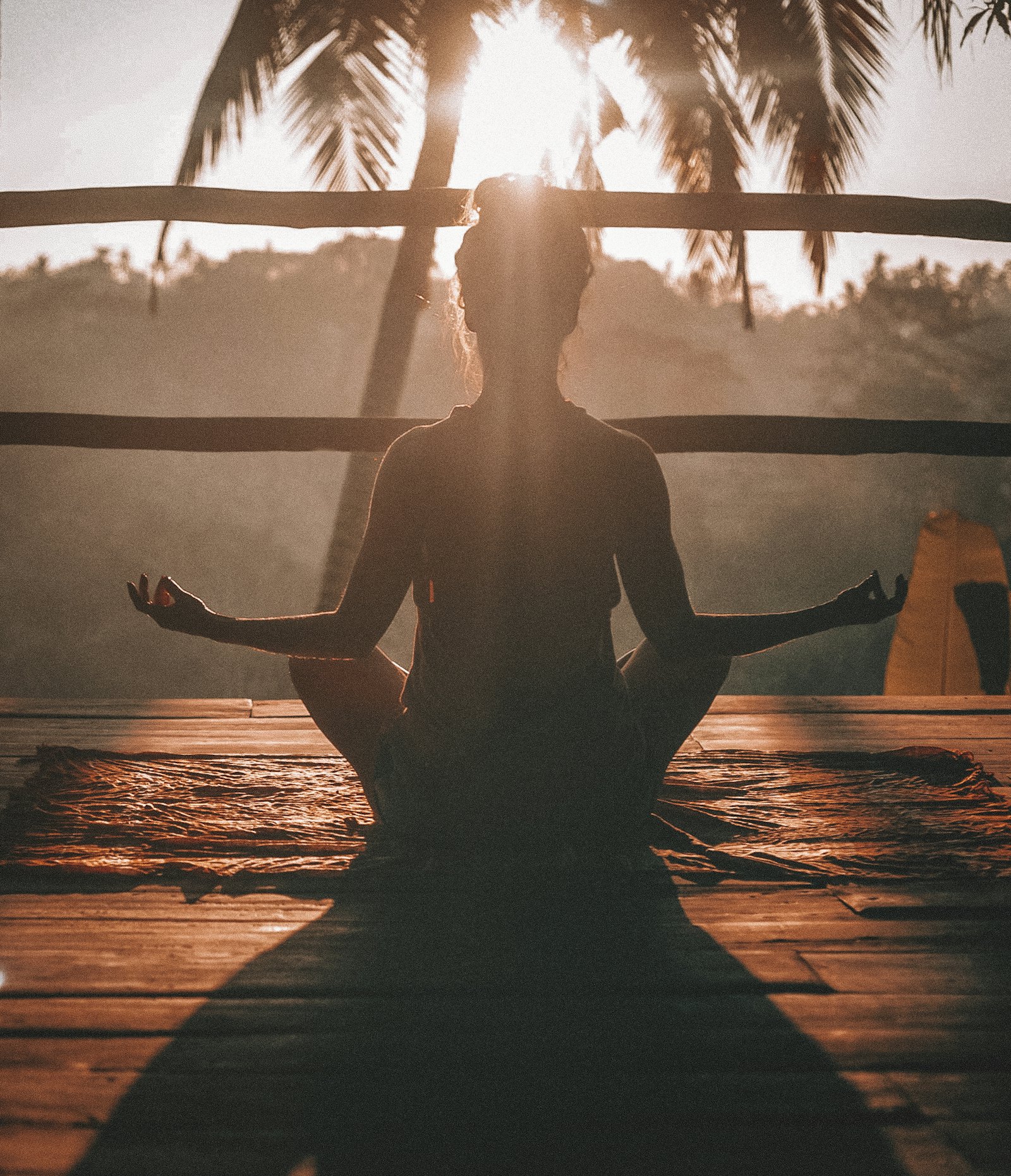 Person meditating at sunset
