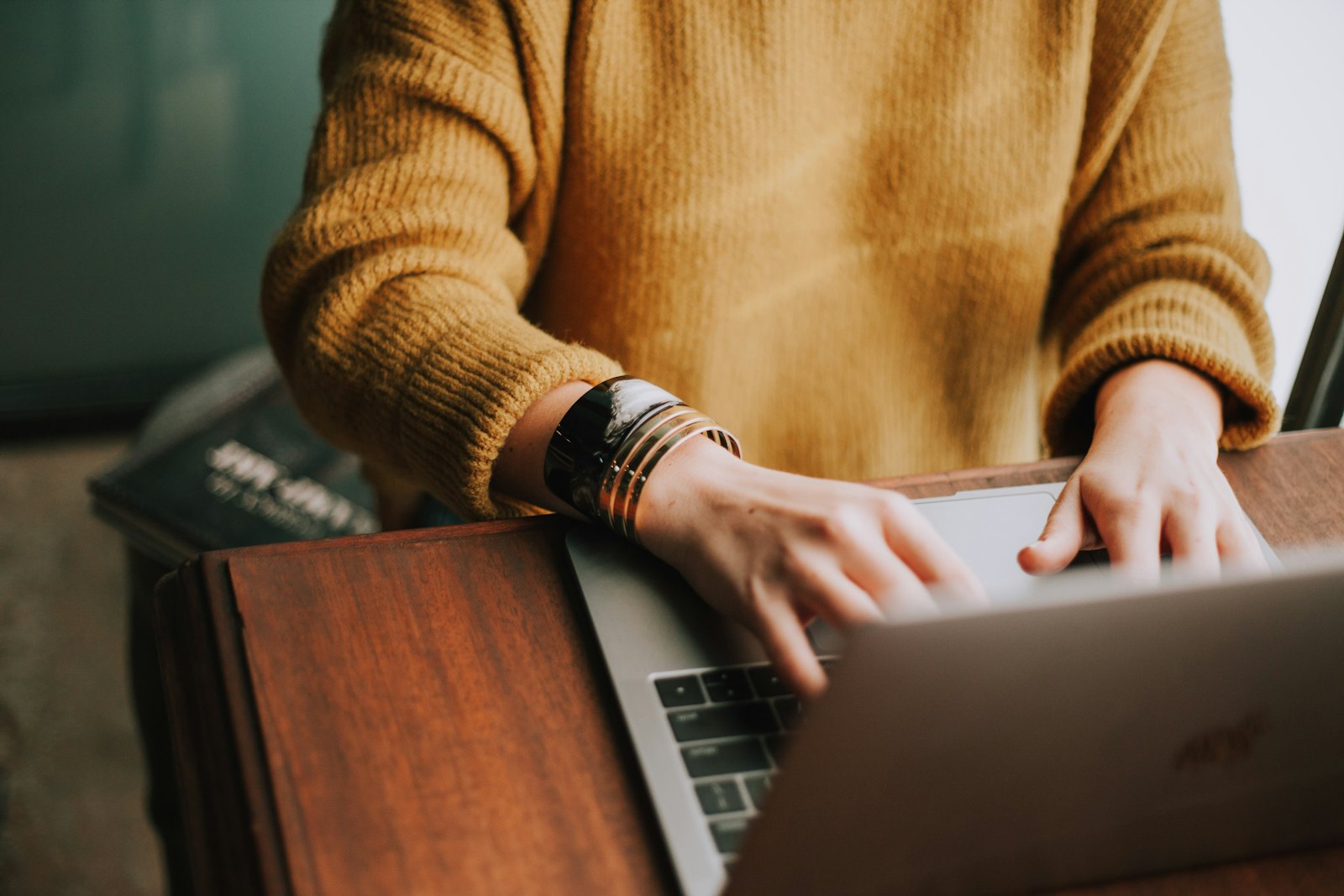 Laptop and cosy sweater at a desk